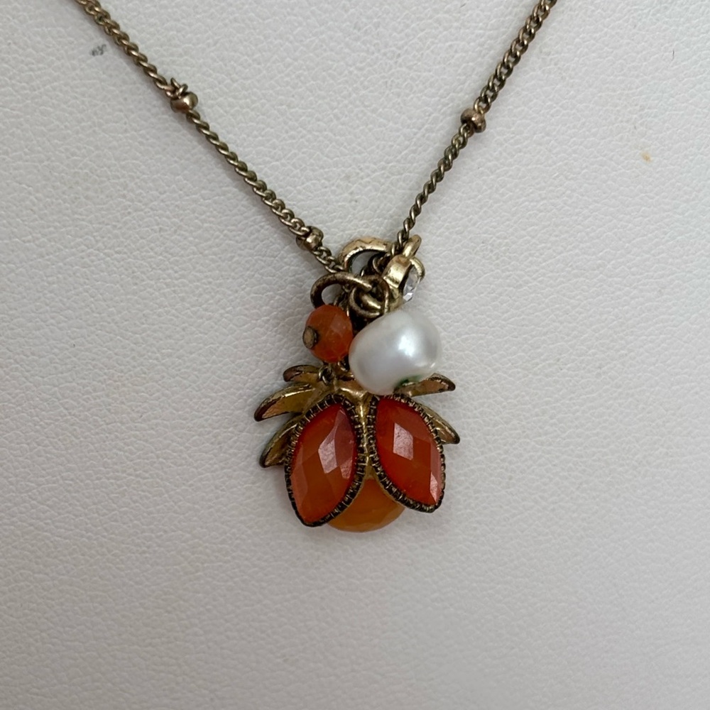 Stations pendant necklace/ gold tone/ pendant has orange color stones